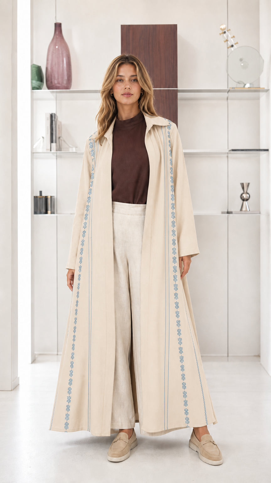 Model wearing Cream beige open front maxi abaya coat with embroidered borders