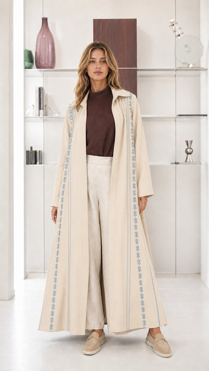 Model wearing Cream beige open front maxi abaya coat with embroidered borders