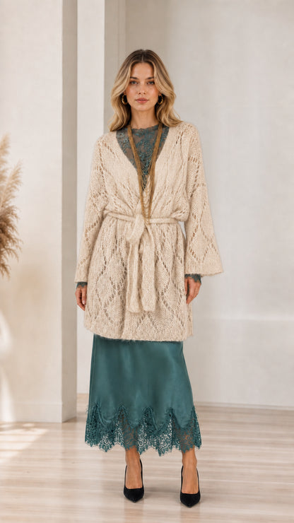 Model wearing beige open front knit cardigan with belt
