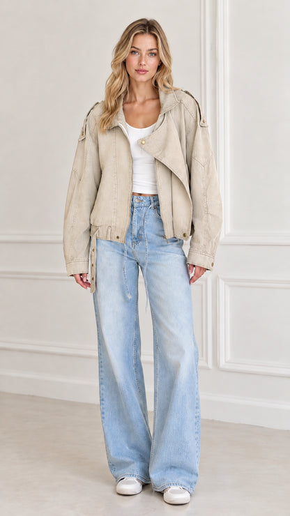 Model wearing Beige washed twill utility jacket styled with light blue jeans