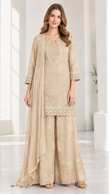 Woman wearing champagne beige embroidered 3-piece kurta sharara suit set