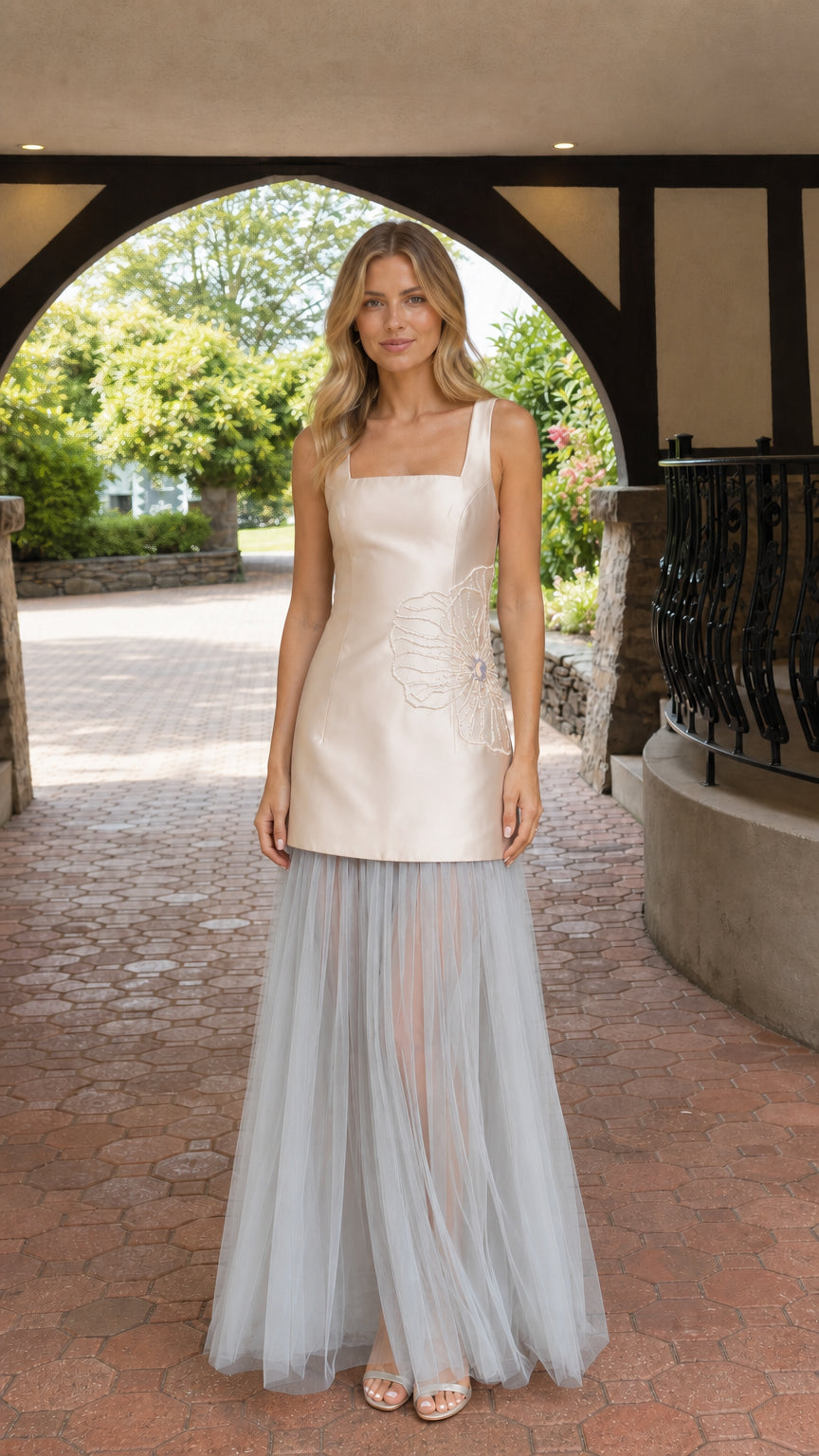 Model wearing champagne drop waist square neck maxi gown with sheer tulle skirt