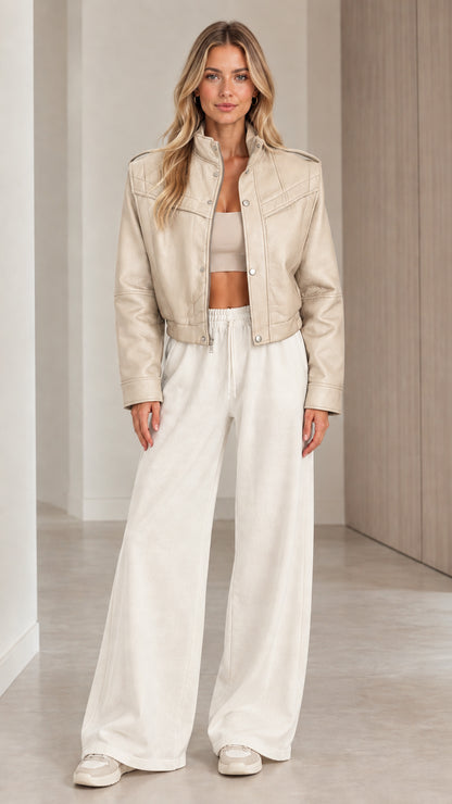 Front full view of woman wearing the cropped faux leather jacket in Beige