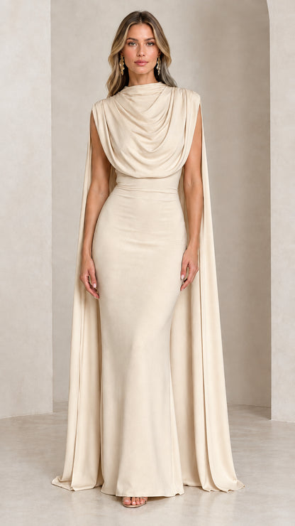 Front view of model wearing the champagne cream draped cowl neck cape evening gown