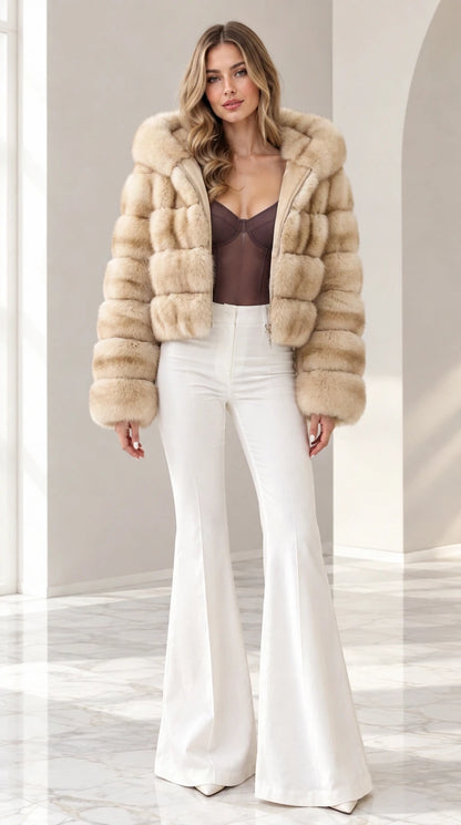 Model wearing beige champagne cropped hooded faux fur jacket with white pants
