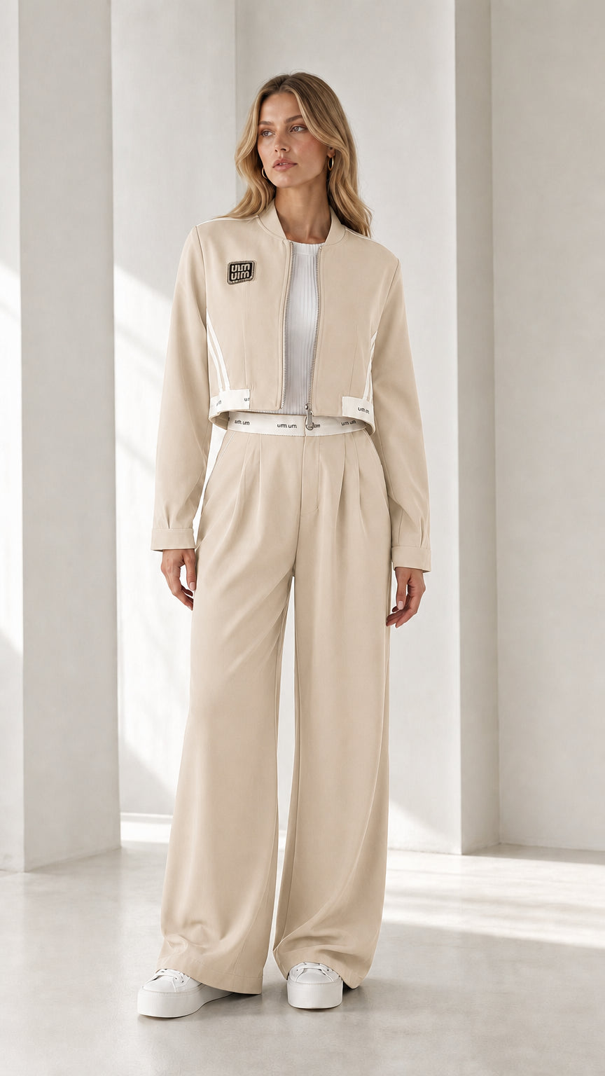 Full view of model wearing beige cropped jacket and wide-leg pants set