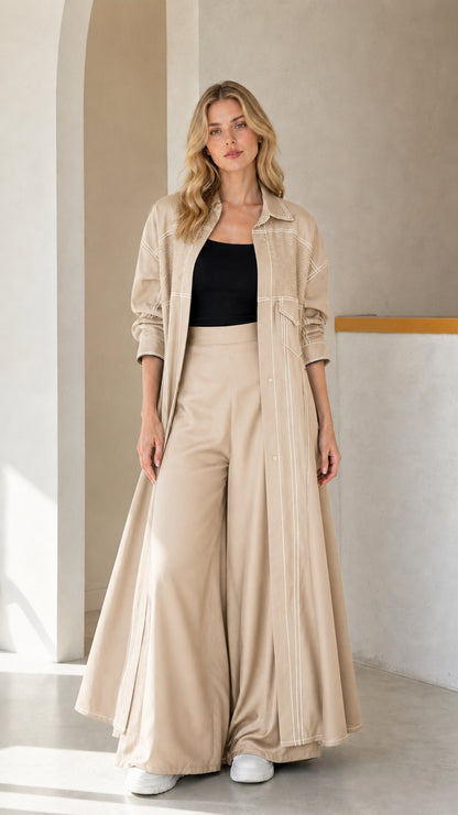 Full-length look of woman wearing Beige maxi duster coat and matching wide-leg pants