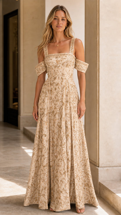 Model wearing champagne ivory embroidered cold-shoulder evening maxi dress
