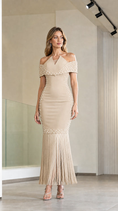 Model wearing champagne beige off-the-shoulder pearl embellished fringe evening dress