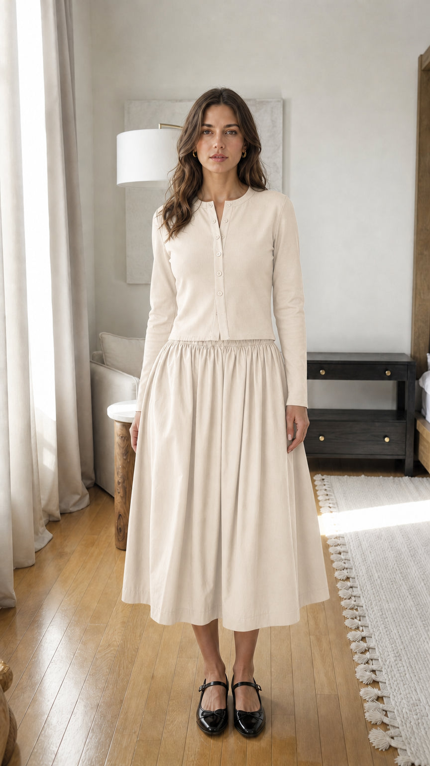 Woman wearing beige long-sleeve ribbed top and midi skirt set