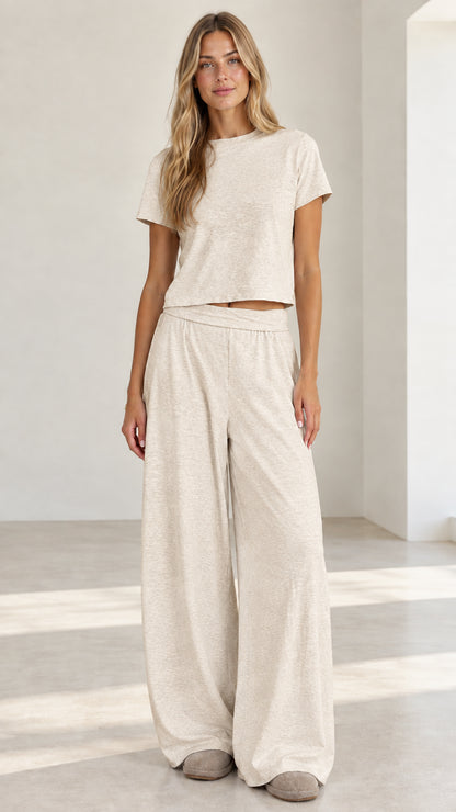 Model wearing oatmeal cream short sleeve crop top and wide leg lounge set