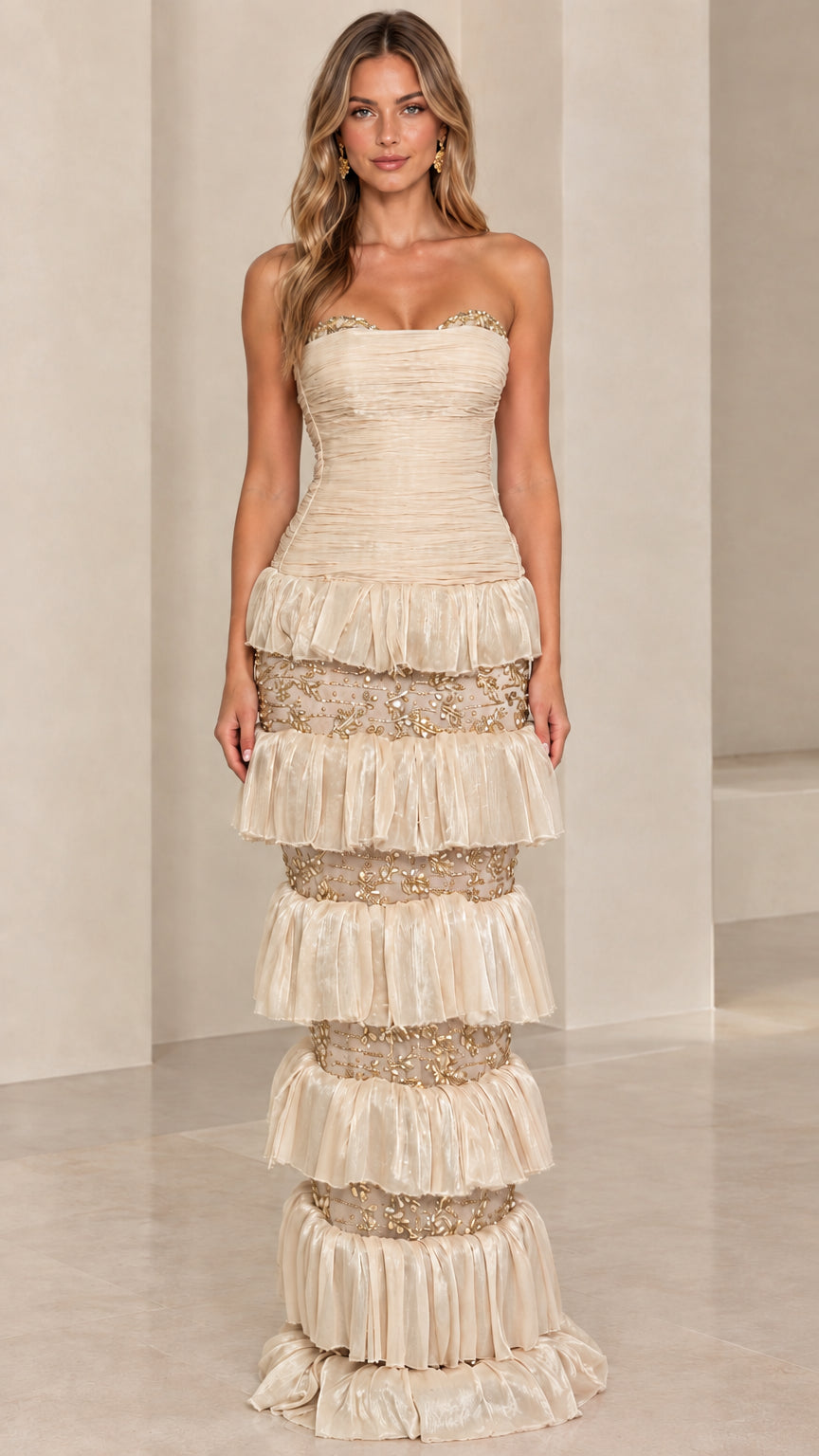 Front view of model wearing Champagne cream strapless tiered embroidered gown