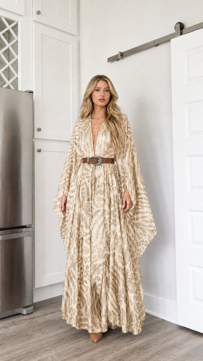 Woman wearing beige cream colored abstract animal print boho maxi dress