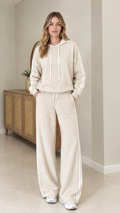 Model wearing Oatmeal beige two-piece tracksuit set with white side stripes