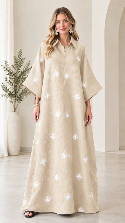 Front view of model wearing beige oatmeal embroidered crinkle maxi shirt dress