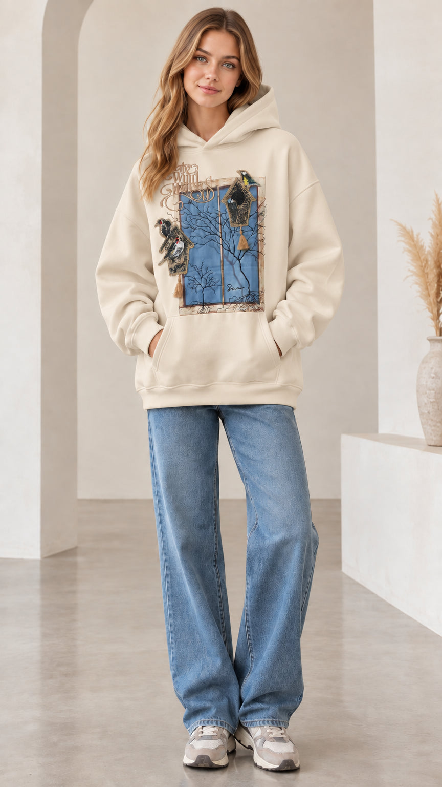 Front view of woman wearing beige off-white vintage nature bird graphic hoodie
