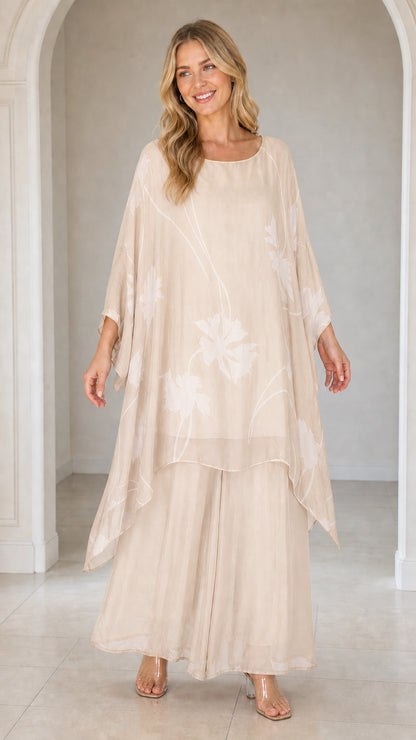 Front view of woman wearing beige floral kaftan set