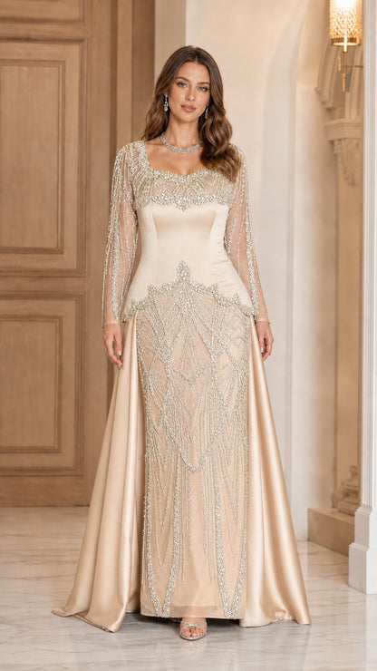 Champagne gold floor-length evening gown with ornate beading and sheer sleeves