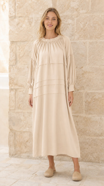 Full front view of model wearing beige tiered maxi dress
