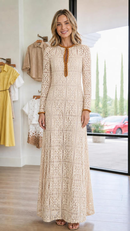 Front view of woman wearing beige long-sleeve lace maxi dress