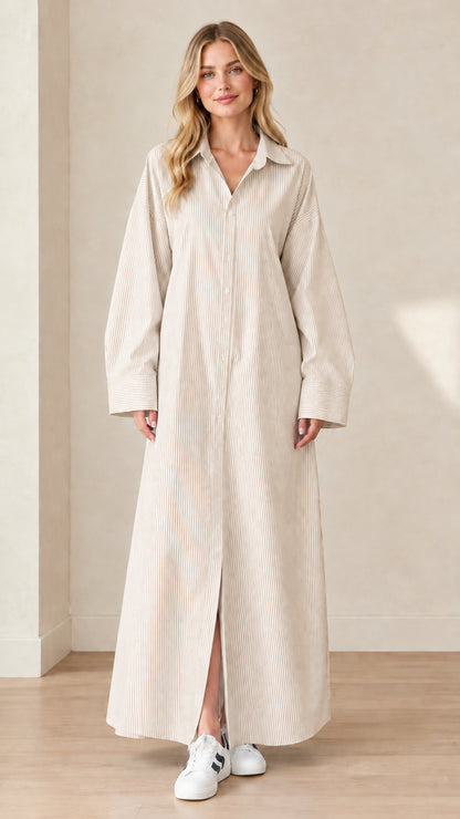 Front view of a model wearing a beige cream and white striped maxi shirt dress
